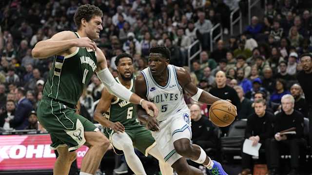 Minnesota Timberwolves guard Anthony Edwards (5) drives for the basket against Milwaukee Bucks center Brook Lopez (11)