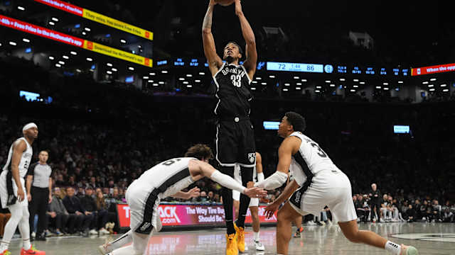 Brooklyn Nets center Nic Claxton (33) shoots a layup against San Antonio Spurs small forward Cedi Osman (16) and San Antonio Spurs small forward Keldon Johnson (3) during the second half at Barclays Center.