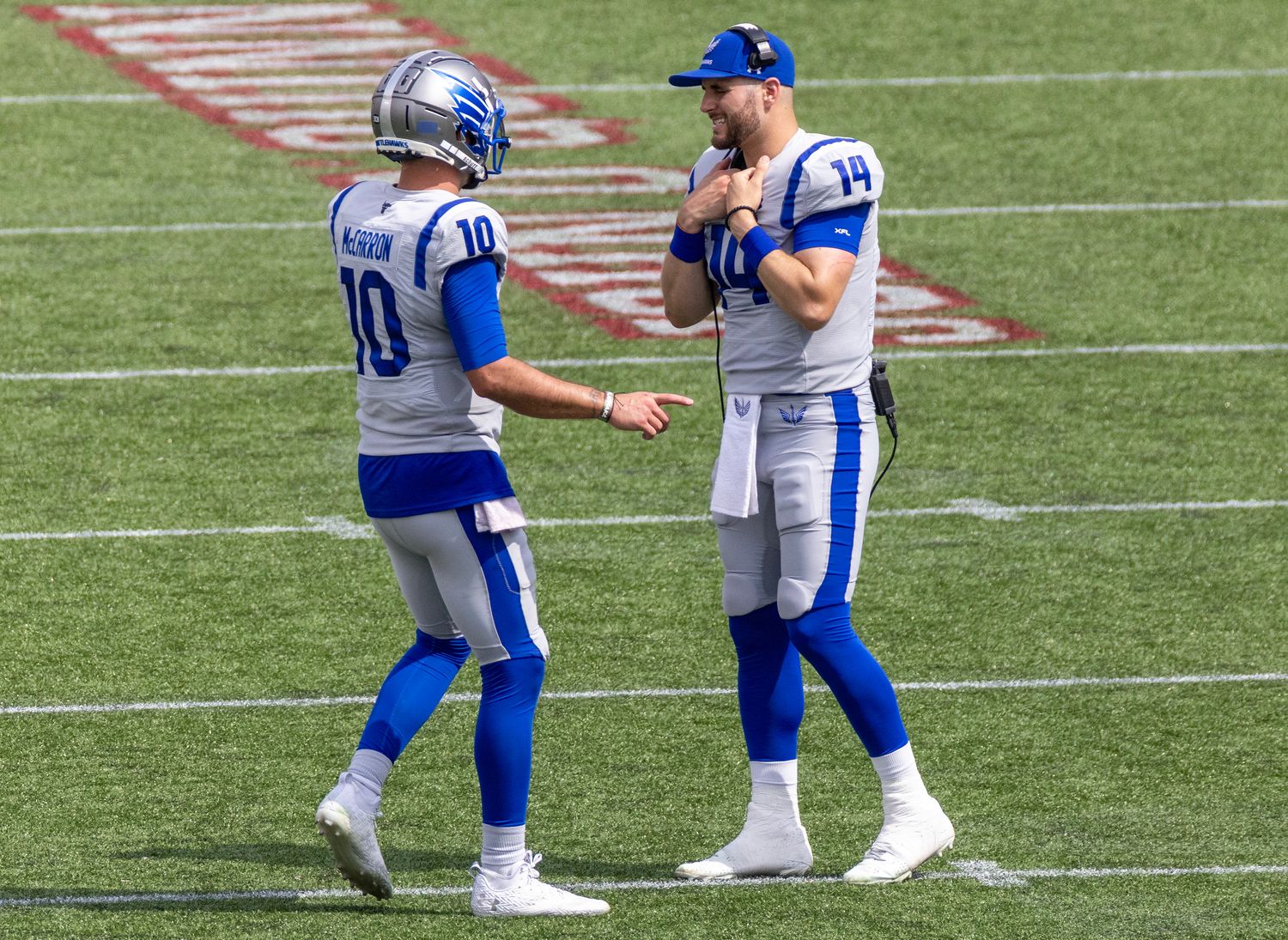 Apr 2, 2023; Houston, TX, USA; Louis Battlehawks quarterback A.J. McCarron (10) talks with quarterback Nick Tianon (14) during a Houston Roughnecks timeout in the fourth quarter at TDECU Stadium. Mandatory Credit: Thomas Shea-USA TODAY Sports  