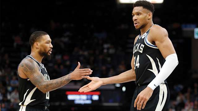 Milwaukee Bucks guard Damian Lillard and Milwaukee Bucks forward Giannis Antetokounmpo high five.