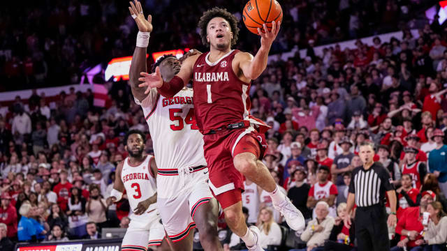 Jan 31, 2024; Athens, Georgia, USA; Alabama Crimson Tide guard Mark Sears (1) goes to the basket behind Georgia Bulldogs center Russel Tchewa (54) during the second half at Stegeman Coliseum. Mandatory Credit: Dale Zanine-USA TODAY Sports  