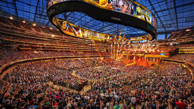 A crowd shot of the conclusion of WrestleMania at a huge American football stadium.