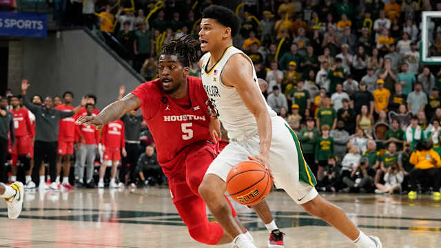 Feb 24, 2024; Waco, Texas, USA; Baylor Bears guard RayJ Dennis (10) works past Houston Cougars forward Ja'Vier Francis (5) during the second half at Paul and Alejandra Foster Pavilion. Mandatory Credit: Raymond Carlin III-USA TODAY Sports