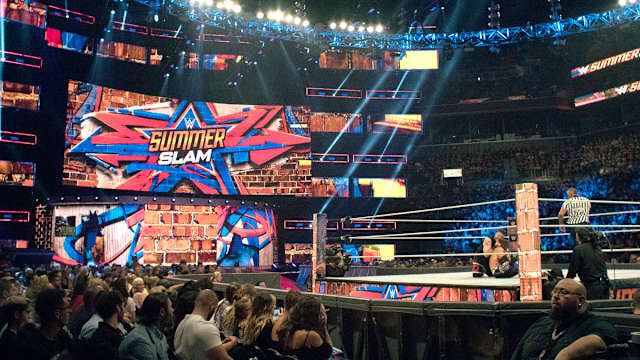 WWE SummerSlam match featuring Kevin Owens in progress.