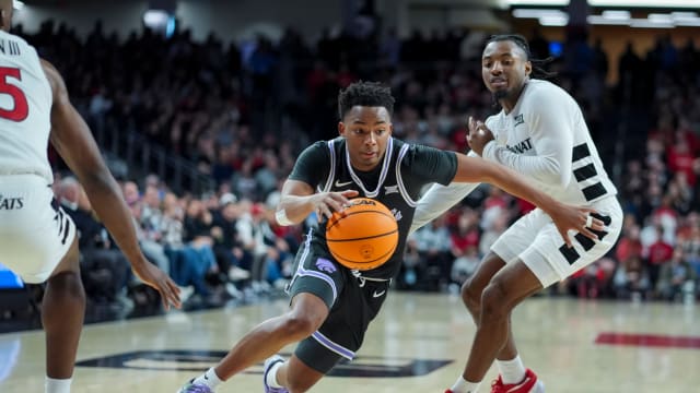 Mar 2, 2024; Cincinnati, Ohio, USA; Kansas State Wildcats guard Tylor Perry (2) drives against Cincinnati Bearcats guard Day Day Thomas (1) in the second half at Fifth Third Arena.
