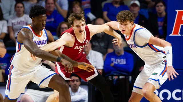 Florida Gators forward Tyrese Samuel (4), Alabama Crimson Tide forward Grant Nelson (2) and Florida Gators center Micah Handlogten (3) go after a loose ball during the first half.