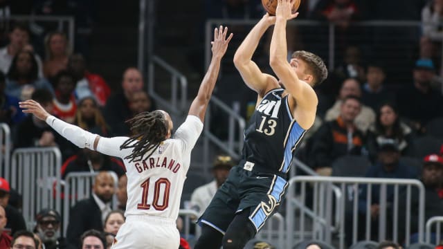 Mar 6, 2024; Atlanta, Georgia, USA; Atlanta Hawks guard Bogdan Bogdanovic (13) shoots over Cleveland Cavaliers guard Darius Garland (10) in the first quarter at State Farm Arena. Mandatory Credit: Brett Davis-USA TODAY Sports