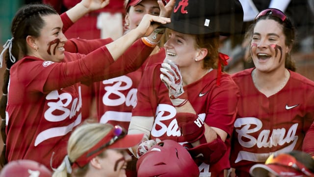 Teammates celebrate at home plate with Alabama hitter Marlie Giles after she hit a solo homer as Alabama played Arizona Saturday at Rhoads Stadium