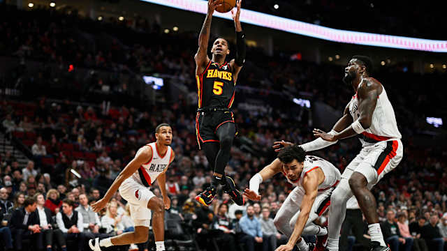 Mar 13, 2024; Portland, Oregon, USA; Atlanta Hawks guard Dejounte Murray (5) scores a basket on a layup during the first half against Portland Trail Blazers forward Justin Minaya (24), forward Kris Murray (8), and center Deandre Ayton (2) at Moda Center. Mandatory Credit: Troy Wayrynen-USA TODAY Sports
