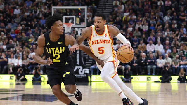 Mar 15, 2024; Salt Lake City, Utah, USA; Atlanta Hawks guard Dejounte Murray (5) drives against Utah Jazz guard Collin Sexton (2) during the second quarter at Delta Center. Mandatory Credit: Rob Gray-USA TODAY Sports