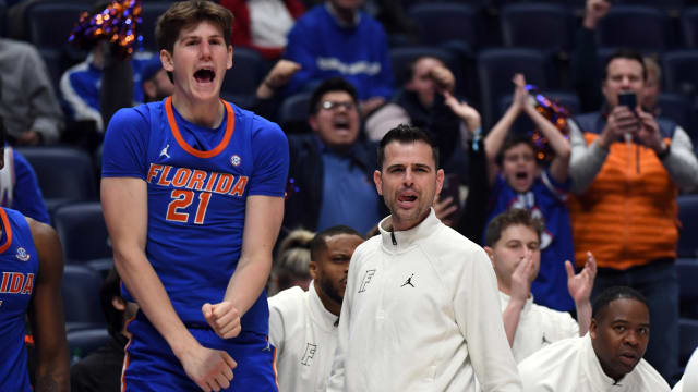 Florida Gators head coach Todd Golden and forward Alex Condon (21) celebrate on the sideline in the closing minute of the win against the Alabama Crimson Tide at Bridgestone Arena.