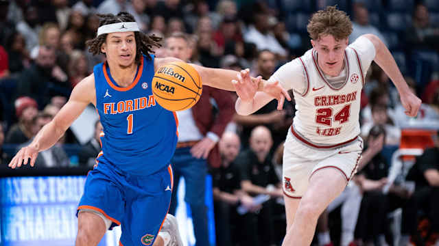 Florida Gators guard Walter Clayton Jr. (1) and Alabama Crimson Tide forward Sam Walters (24) race to the ball during their SEC Men's Basketball Tournament quarterfinal game at Bridgestone Arena in Nashville