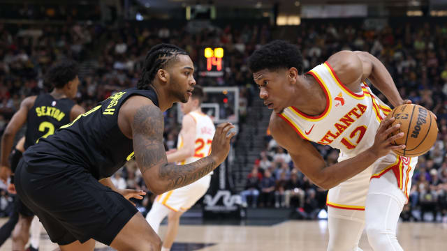 Mar 15, 2024; Salt Lake City, Utah, USA; Atlanta Hawks forward De'Andre Hunter (12) looks to move the ball against Utah Jazz forward Brice Sensabaugh (8) during the second quarter at Delta Center. Mandatory Credit: Rob Gray-USA TODAY Sports