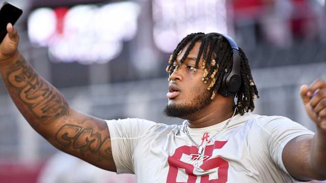 Nov 4, 2023; Tuscaloosa, Alabama, USA; Alabama Crimson Tide offensive lineman JC Latham (65) stretches on the field before a game against the LSU Tigers at Bryant-Denny Stadium. Mandatory Credit: Gary Cosby Jr.-USA TODAY Sports