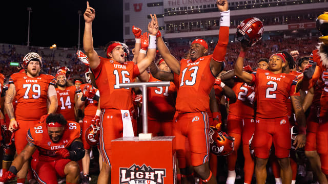 Aug 31, 2023; Salt Lake City, Utah, USA; Utah Utes quarterback Bryson Barnes (16) and quarterback Nate Johnson (13) celebrate their win and combined effort against the Florida Gators at Rice-Eccles Stadium. Mandatory Credit: Jeff Swinger-USA TODAY Sports