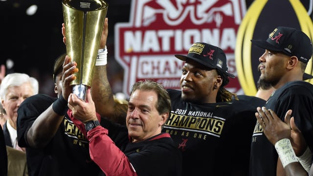 Jan 11, 2016; Glendale, AZ, USA; Alabama Crimson Tide head coach Nick Saban and running back Derrick Henry (2) celebrate with the 2016 CFP National Championship trophy after beating the Clemson Tigers at University of Phoenix Stadium.