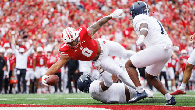 Sep 16, 2023; Madison, Wisconsin, USA; Wisconsin Badgers running back Braelon Allen (0) holds the football out to score a touchdown during the third quarter against the Georgia Southern Eagles at Camp Randall Stadium. Mandatory Credit: Jeff Hanisch-USA TODAY Sports