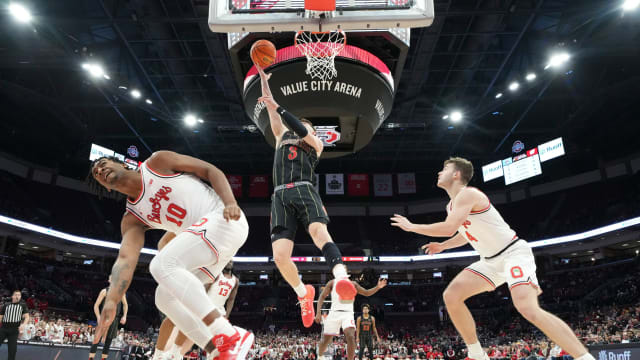 Feb 2, 2023; Columbus, OH, USA; Wisconsin Badgers guard Connor Essegian (3) shoots between Ohio State Buckeyes forward Brice Sensabaugh (10) and guard Sean McNeil (4) during the first half of the NCAA men s basketball game at Value City Arena. Ohio State lost 65-60. Mandatory Credit: Adam Cairns-The Columbus Dispatch Basketball Ceb Mbk Wisconsin Wisconsin At Ohio State