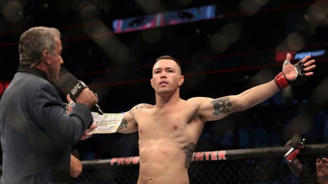 Colby Covington spreads his arm out and poses in front of a live crowd inside the Prudential Center.