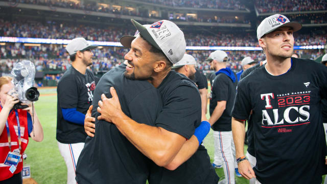 Texas Rangers second baseman Marcus Semien, middle, hugs third baseman Josh Jung as Evan Carter, right, looks on, after winning their ALDS against the Baltimore Orioles Tuesday night at Globe Life Field.