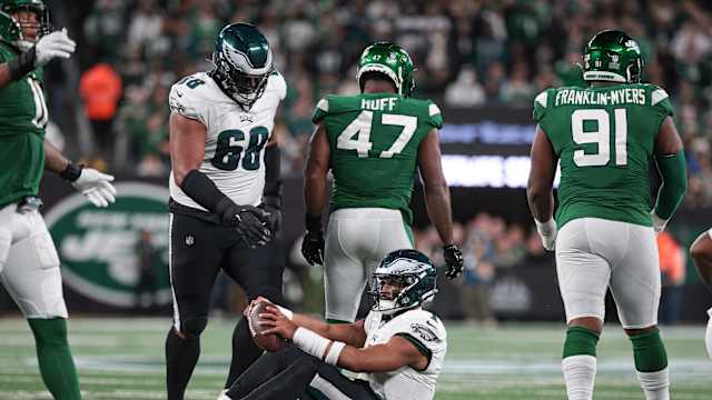 Jets' DE Bryce Huff (47) walks away after sacking Eagles' QB Jalen Hurts