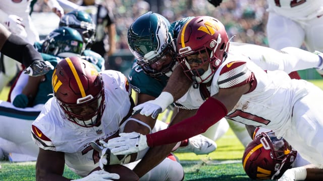 Oct 1, 2023; Philadelphia, Pennsylvania, USA; Washington Commanders offensive tackle Saahdiq Charles (77) and wide receiver Terry McLaurin (17) recover a fumble in the end zone past Philadelphia Eagles defensive end Brandon Graham (55) for a touchdown during the second quarter at Lincoln Financial Field.