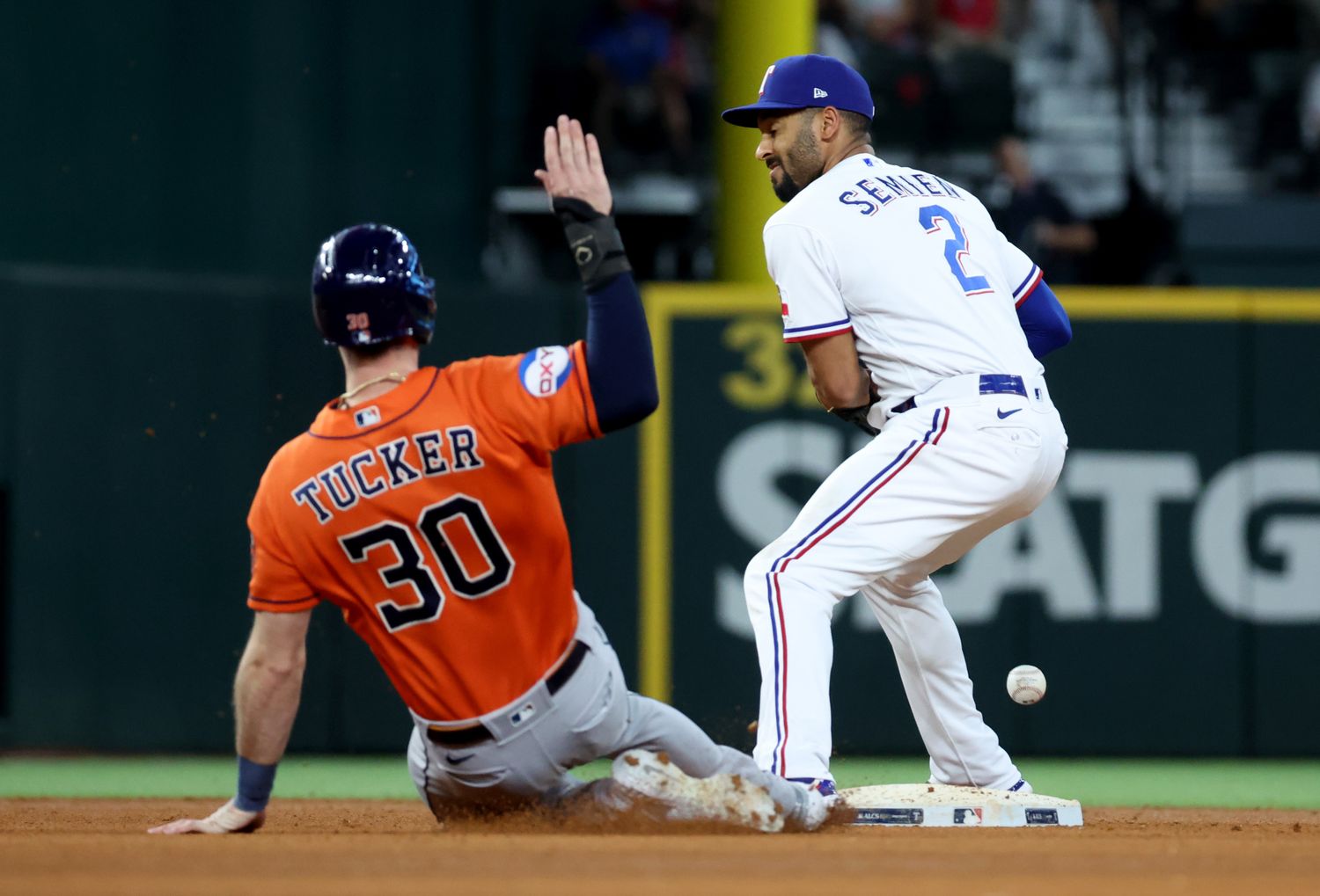 Texas Rangers second baseman Marcus Semien drops the ball as Houston Astros right fielder Kyle Tucker slides into second during the fifth inning of Game 5 of the ALCS Friday at Globe Life Field.