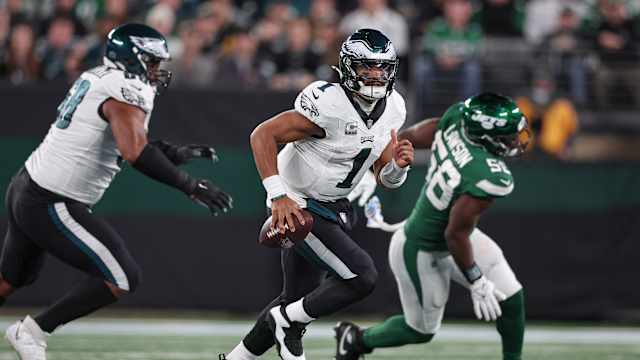 Jets' DE Carl Lawson (58) pursues Eagles' QB Jalen Hurts (1)