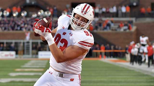 Oct 21, 2023; Champaign, Illinois, USA; Wisconsin Badgers defensive end Isaac Townsend (93) catches a touchdown during the second half against the Illinois Fighting Illini at Memorial Stadium. Mandatory Credit: Ron Johnson-USA TODAY Sports