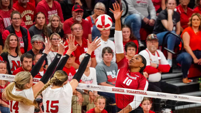 Oct 21, 2023; Lincoln, NE, USA; Wisconsin Badgers middle blocker Devyn Robinson (10) attacks against Nebraska Cornhuskers outside hitter Ally Batenhorst (14) and middle blocker Andi Jackson (15) during the second set. Mandatory Credit: Dylan Widger-USA TODAY Sports