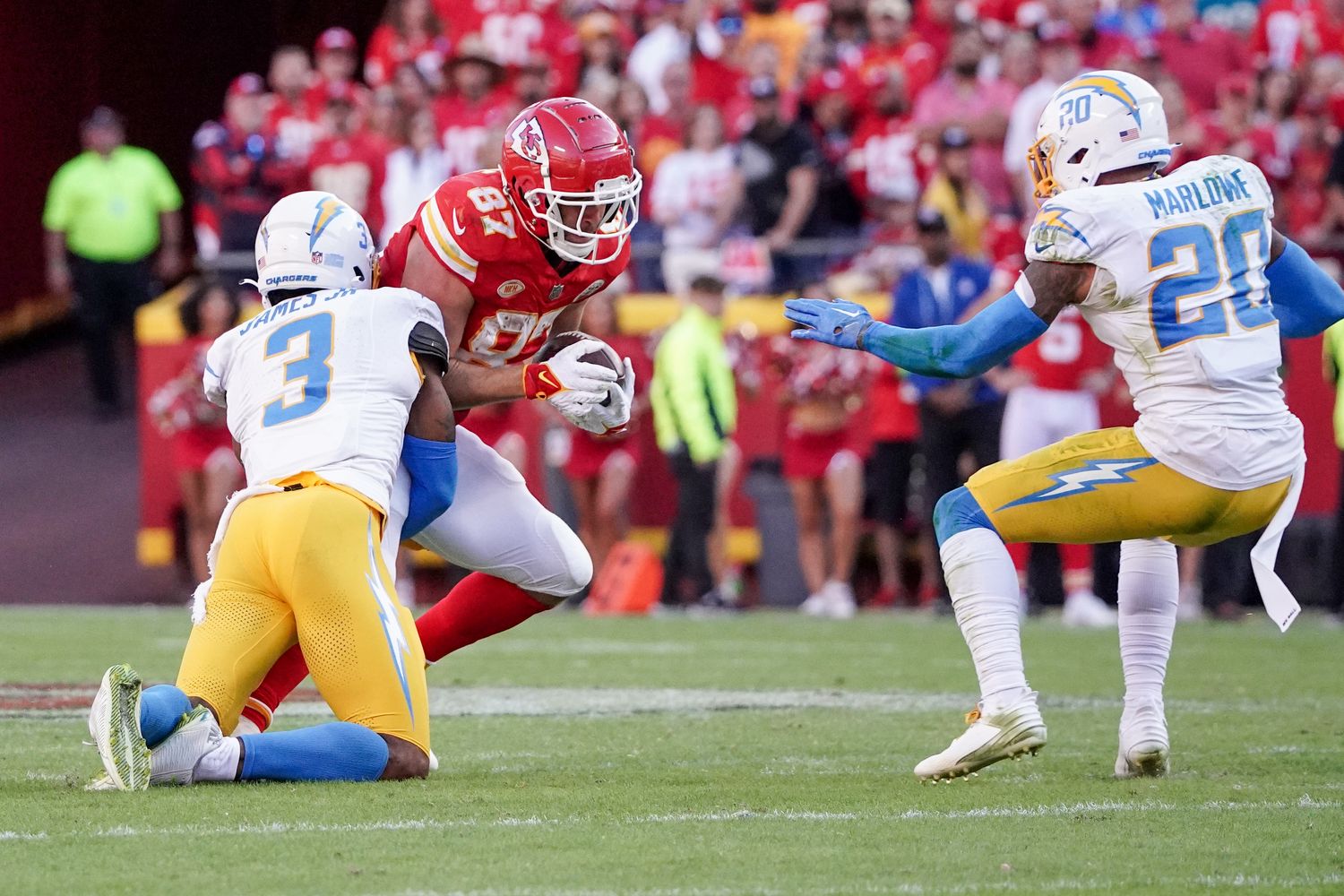Oct 22, 2023; Kansas City, Missouri, USA; Kansas City Chiefs tight end Travis Kelce (87) runs the ball as Los Angeles Chargers safety Derwin James Jr. (3) makes the tackle during the first half at GEHA Field at Arrowhead Stadium. Mandatory Credit: Denny Medley-USA TODAY Sports  