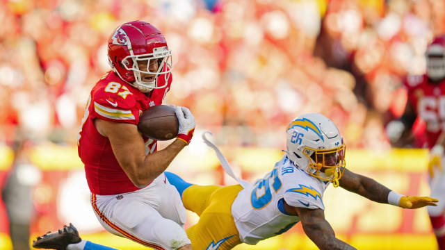 Oct 22, 2023; Kansas City, Missouri, USA; Kansas City Chiefs tight end Travis Kelce (87) catches a pass against Los Angeles Chargers cornerback Asante Samuel Jr. (26) during the second half at GEHA Field at Arrowhead Stadium. Mandatory Credit: Jay Biggerstaff-USA TODAY Sports  