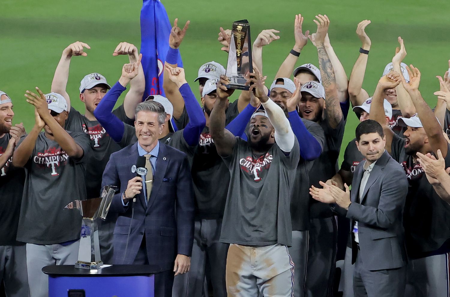 Oct 23, 2023; Houston, Texas, USA; Texas Rangers right fielder Adolis Garcia (53) celebrates with the American League championship series MVP trophy after winning game seven in the ALCS against the Houston Astros for the 2023 MLB playoffs at Minute Maid Park. Mandatory Credit: Erik Williams-USA TODAY Sports