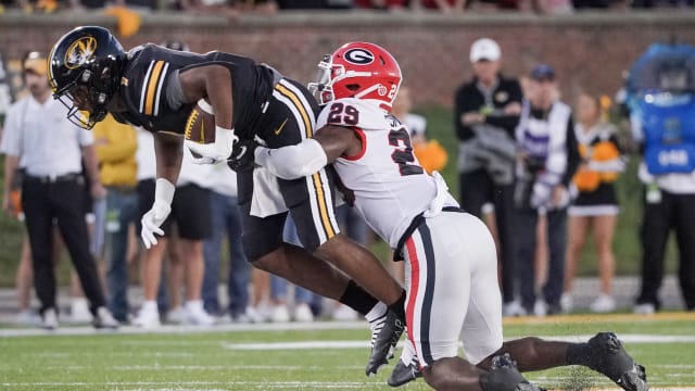 Oct 1, 2022; Columbia, Missouri, USA; Missouri Tigers wide receiver Tauskie Dove (1) is tackled by Georgia Bulldogs defensive back Christopher Smith (29) during the first half at Faurot Field at Memorial Stadium. Mandatory Credit: Denny Medley-USA TODAY Sports
