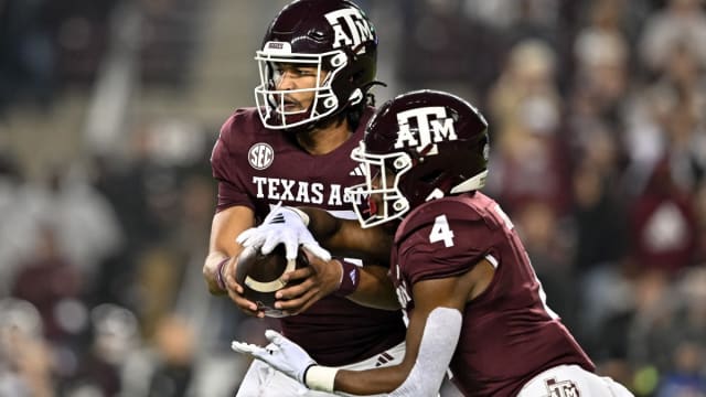 Nov 11, 2023; College Station, Texas, USA; Texas A&M Aggies quarterback Jaylen Henderson (16) hands off the ball to running back Amari Daniels (4) during the first quarter at Kyle Field.