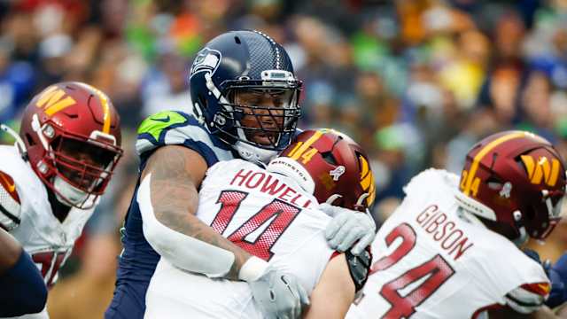 Seattle Seahawks defensive end Leonard Williams (99) sacks Washington Commanders quarterback Sam Howell (14) during the second quarter at Lumen Field.