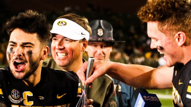 Missouri running back Cody Schrader celebrates with head coach Eli Drinkwitz and quarterback Brady Cook after a college football game at Faurot Field on Nov. 11, 2023, in Columbia, Mo.