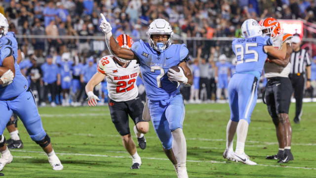 Nov 11, 2023; Orlando, Florida, USA; UCF Knights running back RJ Harvey (7) carries the ball for a touchdown during the second half against the Oklahoma State Cowboys at FBC Mortgage Stadium. 