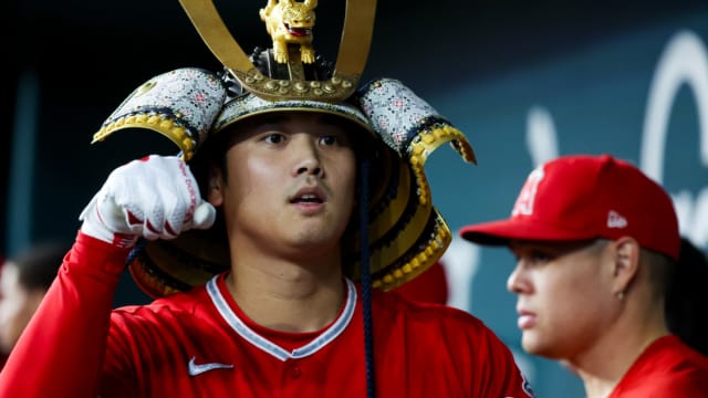 Aug 16, 2023; Arlington, Texas, USA; Los Angeles Angels designated hitter Shohei Ohtani (17) celebrates with teammates while wearing a samurai helmet after hitting a home run during the first inning against the Texas Rangers at Globe Life Field.
