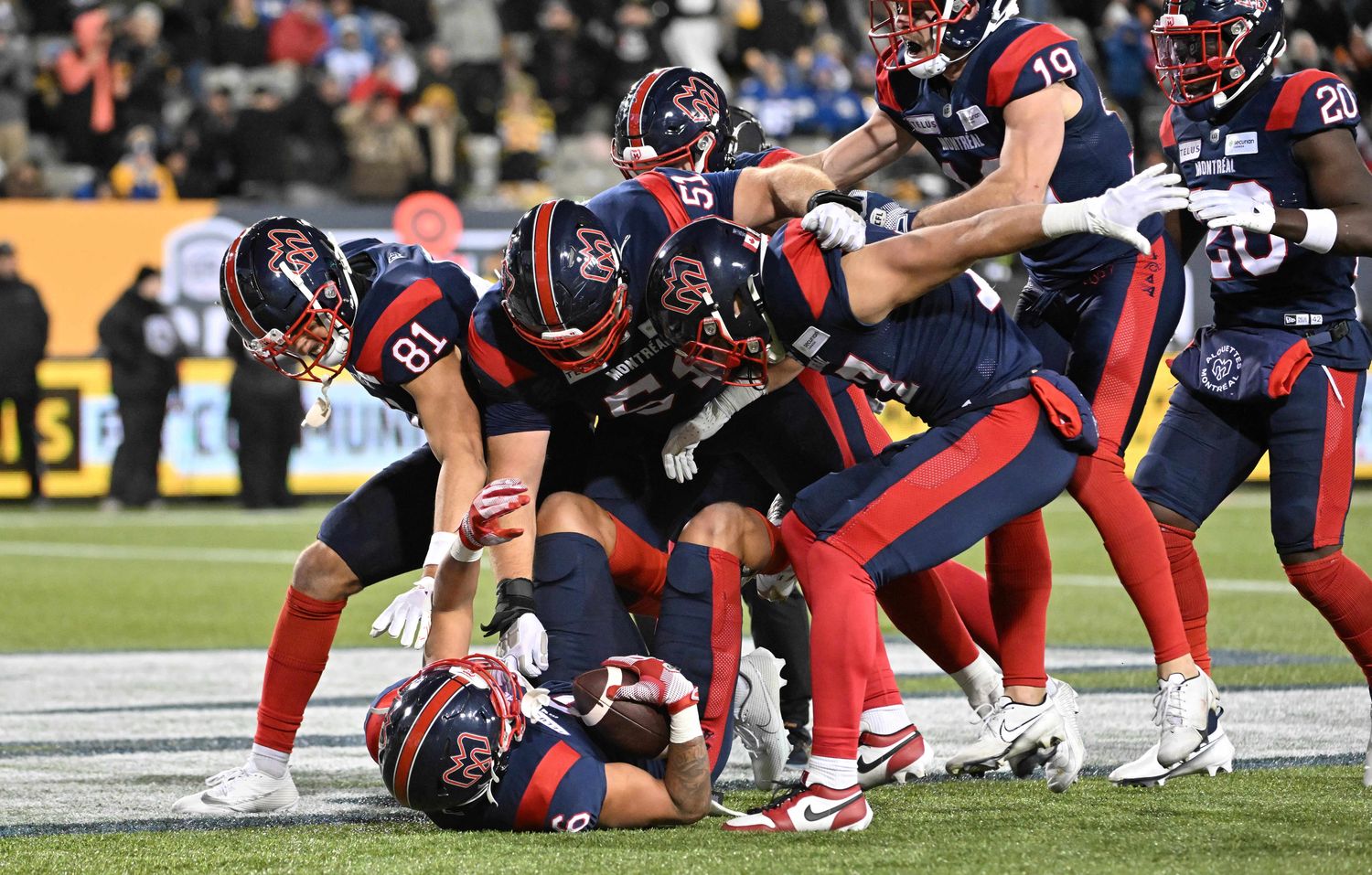 Nov 19, 2023; Hamilton, Ontario, CAN; Montreal Alouettes wide receiver Tyson Philpot (6) is mobbed by teammates after scoring the winning touchdown with 13 seconds left against the Winnipeg Blue Bombers at Tim Hortons Field. Mandatory Credit: Dan Hamilton-USA TODAY Sports