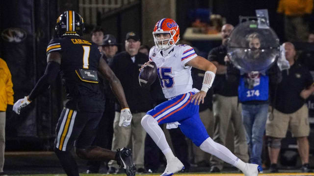 Nov 18, 2023; Columbia, Missouri, USA; Florida Gators quarterback Graham Mertz (15) runs the ball as Missouri Tigers defensive back JC Carlies (1) chases during the first half at Faurot Field at Memorial Stadium. Mandatory Credit: Denny Medley-USA TODAY Sports
