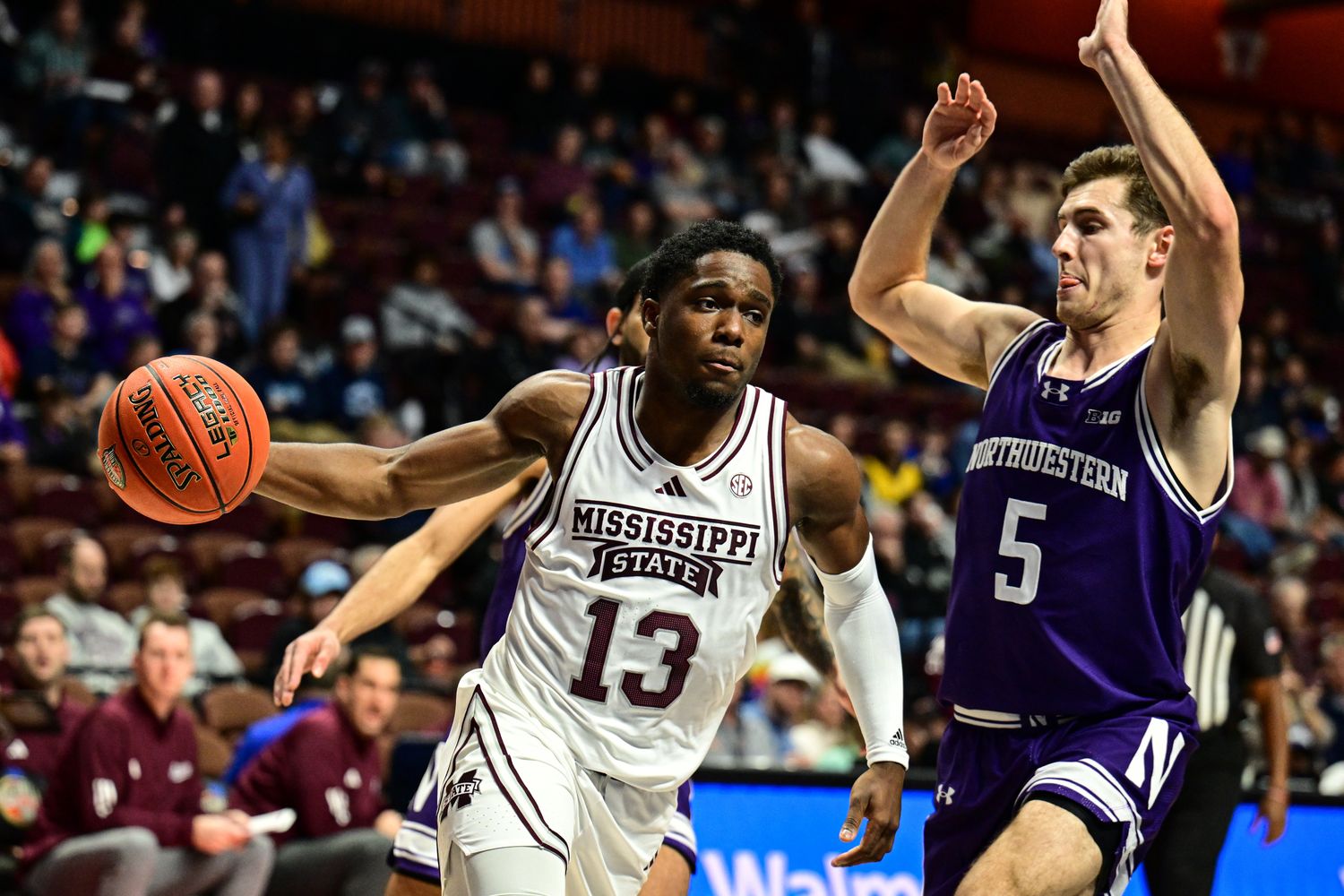 Mississippi State Bulldogs guard Josh Hubbard (13) dribbles the ball challenged by Northwestern Wildcats guard Ryan Langborg (5) during the second half at Mohegan Sun Arena.