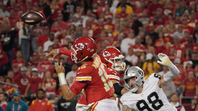 Oct 10, 2022; Kansas City, Missouri, USA; Kansas City Chiefs quarterback Patrick Mahomes (15) throws a pass defended by Las Vegas Raiders defensive end Maxx Crosby (98) in the second half at GEHA Field at Arrowhead Stadium. Mandatory Credit: Denny Medley-USA TODAY Sports  