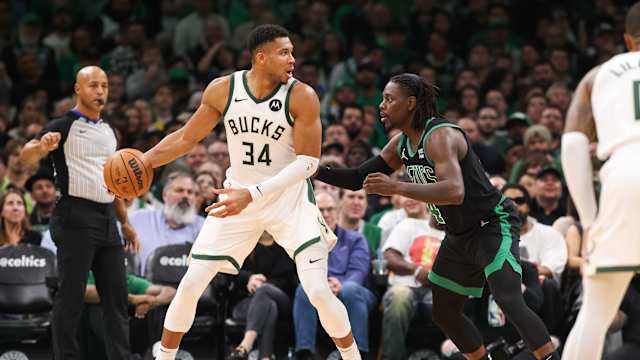 Milwaukee Bucks forward Giannis Antetokounmpo (34) defended by Boston Celtics guard Jrue Holiday (4) 
