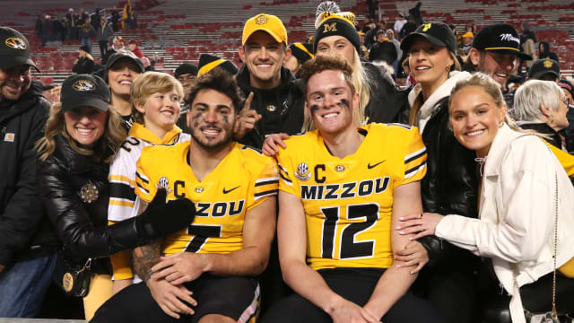 Nov 24, 2023; Fayetteville, Arkansas, USA; Missouri Tigers running back Cody Schrader (7) and quarterback Brady Cook (12) pose with fans after the game against the Arkansas Razorbacks at Donald W. Reynolds Razorback Stadium. Missouri won 48-14. Mandatory Credit: Nelson Chenault-USA TODAY Sports