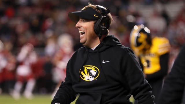 Nov 24, 2023; Fayetteville, Arkansas, USA; Missouri Tigers head coach Eli Drinkwitz celebrates after a defensive touchdown in the third quarter against the Arkansas Razorbacks at Donald W. Reynolds Razorback Stadium. Missouri won 48-14.