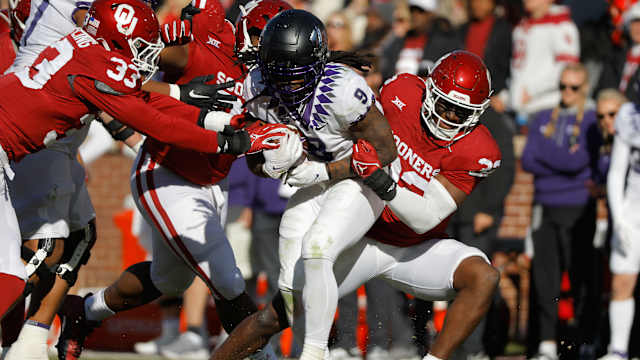 Nov 24, 2023; Norman, Oklahoma, USA; Oklahoma Sooners defensive lineman R Mason Thomas (32) tackles TCU Horned Frogs running back Emani Bailey (9) at Gaylord Family-Oklahoma Memorial Stadium.