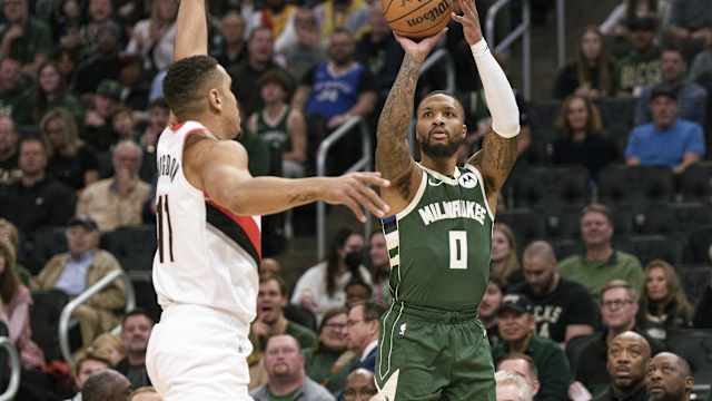 Milwaukee Bucks guard Damian Lillard (0) shoots against Portland Trail Blazers guard Malcolm Brogdon (11) 
