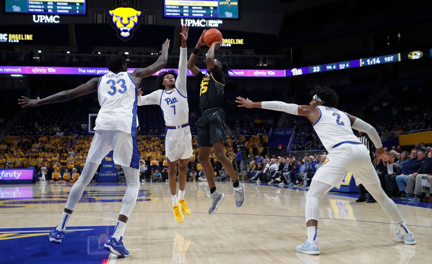 Nov 28, 2023; Pittsburgh, Pennsylvania, USA; Missouri Tigers guard Sean East II (55) shoots the all as Pittsburgh Panthers forward Zack Austin (55) and guard Carlton Carrington (7) and forward Blake Hinson (2) defend during the first half at the Petersen Events Center. 