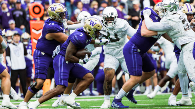 Washington Huskies running back Dillon Johnson rushes against the Oregon Ducks.